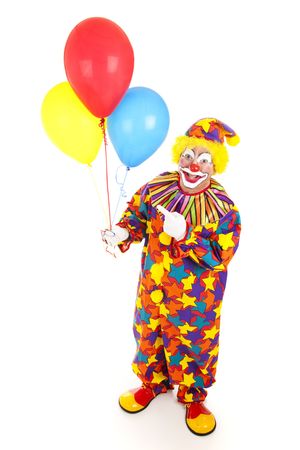 Cheerful birthday clown holding balloons.  Full body isolated on white.  の写真素材