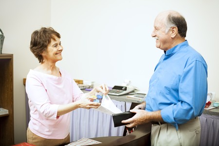 Sales clerk bags up a purchase for a customer.  の写真素材