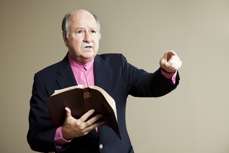Minister delivering a serious sermon in church.  Room for text.の写真素材