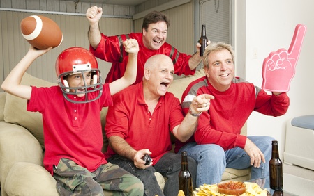 Excited football fans watching their team score a touchdown.  の写真素材