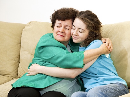 Mother and teenage daughter giving each other a big hug.  の写真素材