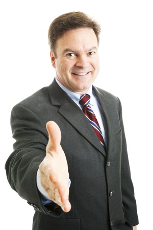 Friendly, mature businessman reaching forward to shake your hand.  Isolated on white.の写真素材