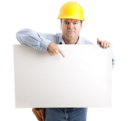 Angry construction worker points to a blank sign, ready for your text.  Isolated on white.  