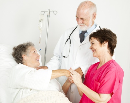 Caring doctor and nurse greeting hospital patient.  の写真素材