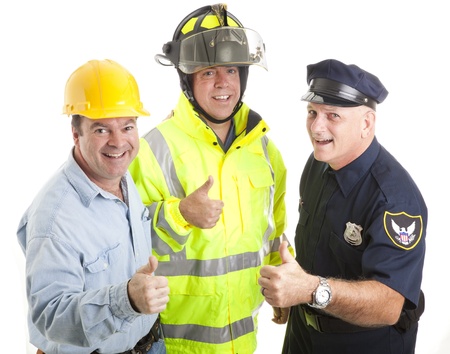 Friendly blue collar workers - fireman, policeman, construction worker - giving thumbs up sign.  Isolated on white.  の写真素材