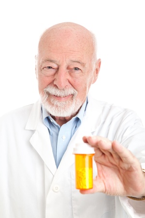 Friendly pharmacist holding a prescription bottle of pills.  White background.  の写真素材
