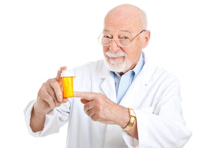 Mature pharmacist recommending a particular medicine.  Isolated on white.  の写真素材