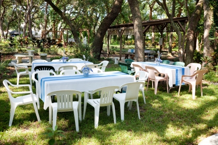 Tables and chairs set up for a garden party, wedding, or other outdoor event.  の写真素材
