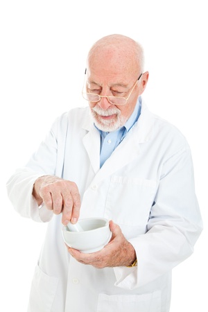 Pharmacist uses a mortar and pestle to mix medicine.  Isolated on white.  の写真素材