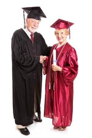 Senior woman graduating and receiving her degree from the dean.  Isolated on white, full body.  の写真素材