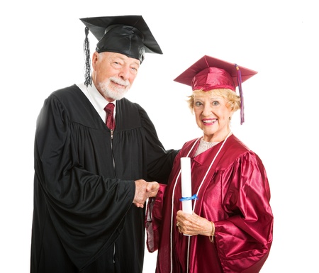 Senior woman receives her diploma at graduation ceremony   Isolated on white   の写真素材