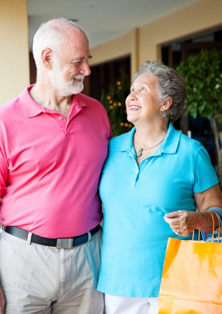 Senior couple on shopping trip look lovingly into each others eyes の写真素材
