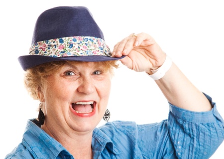 Close up portrait of a middle-aged woman happy, smiling, and laughing while tipping her hat   Isolated on white の写真素材