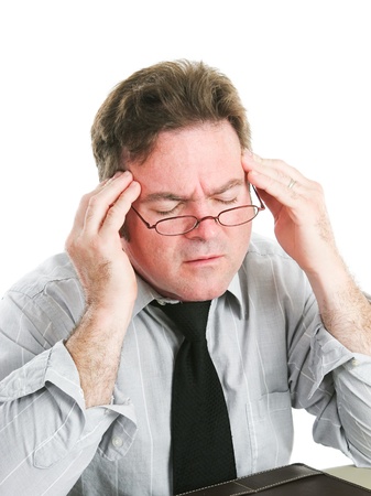 Closeup of a businessman rubbing his temples to relieve a headache.  White background.  の写真素材