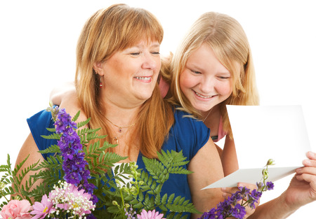 Mother with flowers and a card from her daughter.  Birthday or Mother's Day concept.  の写真素材
