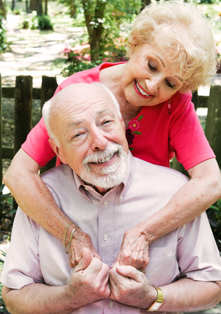 Romantic senior couple in love.  Wife is embracing the husband.  の写真素材