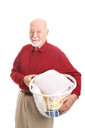 Senior man holding a laundry basket.  Isolated on white.  の写真素材