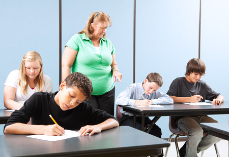 Teacher supervising high school students as they take and achievement test.  の写真素材