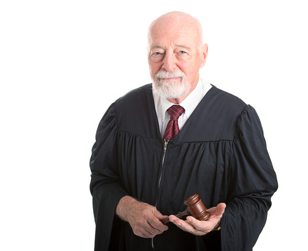 Serious dignified judge with gavel.  Isolated on white.  の写真素材