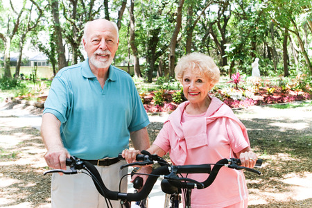 Senior couple riding bicycles to stay in shape.  の写真素材