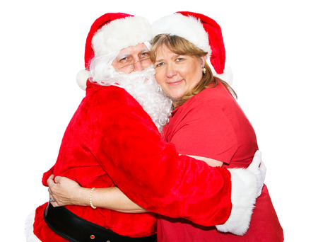 Santa and his wife hugging each other.  Isolated on white.  の写真素材