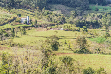 Church and cemetery with fields, forest and dirty road in Venancio Aires, Rio Grande do Sul, Brazilの写真素材