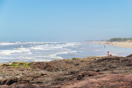 Beach, waves, sand and rocks at Torres beachの写真素材