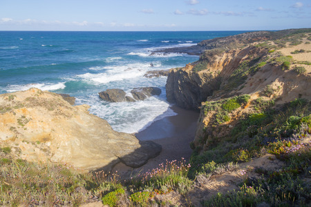 Beach and cliffs in Vila Nova de Milfontes, Alentejo, Portugalの写真素材