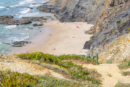 Cliffs, rocks and stairs in Zambujeira do Mar beach, Alentejo, Portugalの写真素材