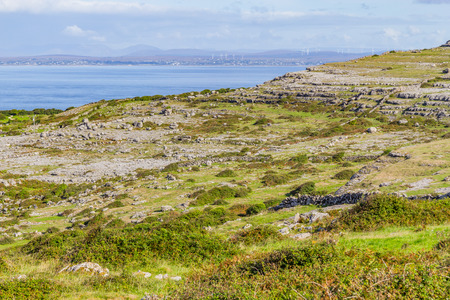 Farms field with with stone walls and Galway bay in background, Clare, Irelandの写真素材
