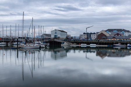 Carrickfergus Harbour with boats and reflection ,Antrim,Northern Ireland, UKの写真素材