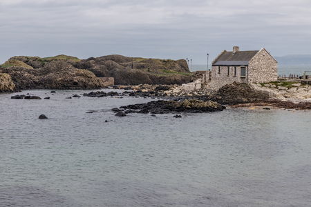 Pier, Beach and rocks in Ballintoy Harbour, Moyle, Northern Ireland, UKの写真素材