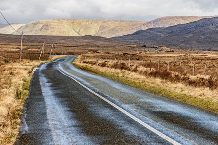 Conemara road with bog and mountains in background, Maam Cross, Galway, Irelandの写真素材