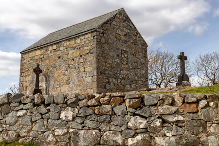 Stone house and cemetery with Celtic cross, Spiddal, Galway, Irelandの写真素材