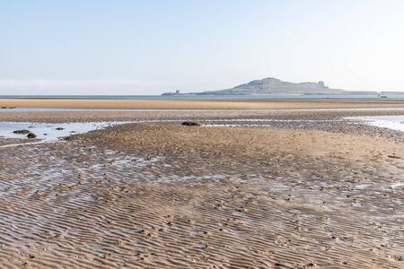 Low tide  in Burrow beach with Ireland's Eyes island in background, Sutton, Dublin, Irelandの写真素材