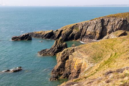 Hiking trail with cliff and vegetation in Howth, Dublin, Irelandの写真素材