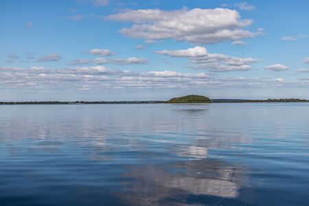 Island, Clouds and reflections in Lough Corrib lake, Cong, Mayo, Irelandの写真素材