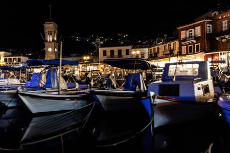 Night lights of Boats and buildings around pier in Hydra Island, Greece