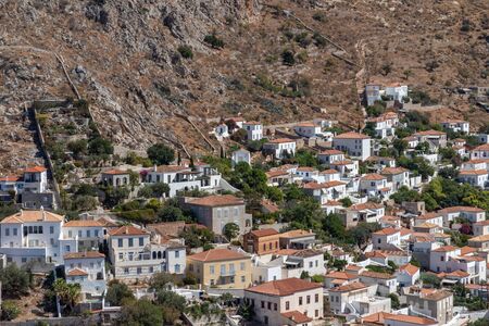 Houses and buildings in the mountains with trees and vegetation in Hydra Island, Greeceの写真素材