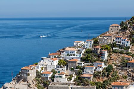 Houses and buildings in the mountains with trees and vegetation in Hydra Island, Greeceの写真素材