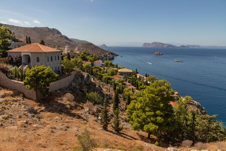 Houses and buildings in the mountains with trees and vegetation in Hydra Island, Greeceの写真素材