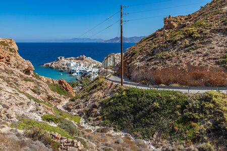 Road to Firopotamos beach with church, houses and cliffs, Milos, Greeceの写真素材