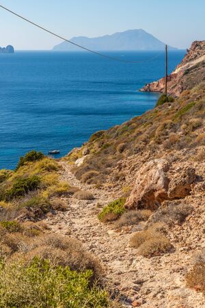 Trail to Fourkovouni beach with cliffs and vegetation, Milos, Greeceの写真素材