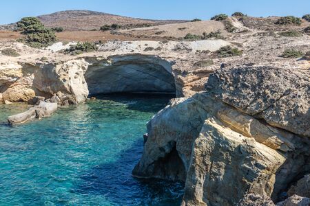 Cave, cliffs and rocks in Agios Konstantinos beach, Milos, Greece