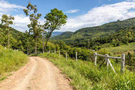 Farm meadow and valley with forest around, Tres Coroas, Rio Grande do Sul, Brazilの写真素材