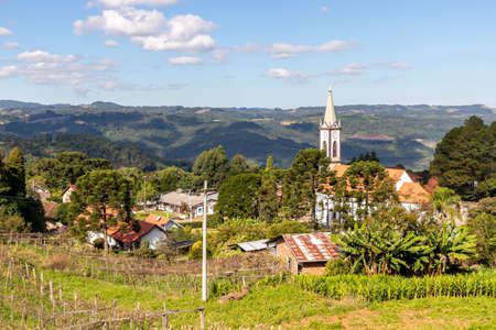 Pinhal alto village view with church, houses and forest in background, Nova Petropolis, Rio Grande do Sul, Brazilの写真素材