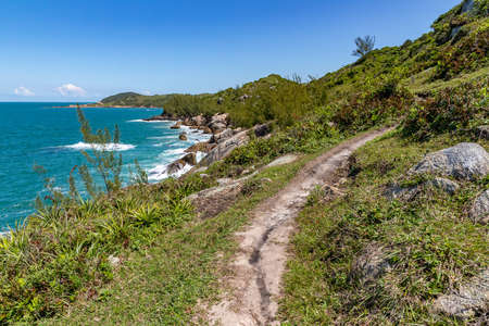 Trail over the cliffs with ocean in background, Praia da Barra, Garopaba, Santa Catarina, Brazilの写真素材
