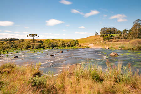 River and Dirty road in farm field, Cambara do Sul, Rio Grande do Sul, Brazilの写真素材