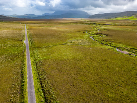 Aerial view of road, river, mountains and fields in Dromalonhurt, Kerry, Irelandの写真素材