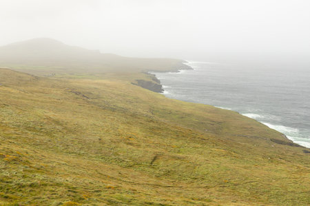 Fog in the fields and ocean, Valentia island, Kerry, Irelandの写真素材